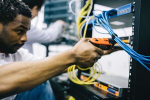 a technician concentrating and using a tool for structured cabling